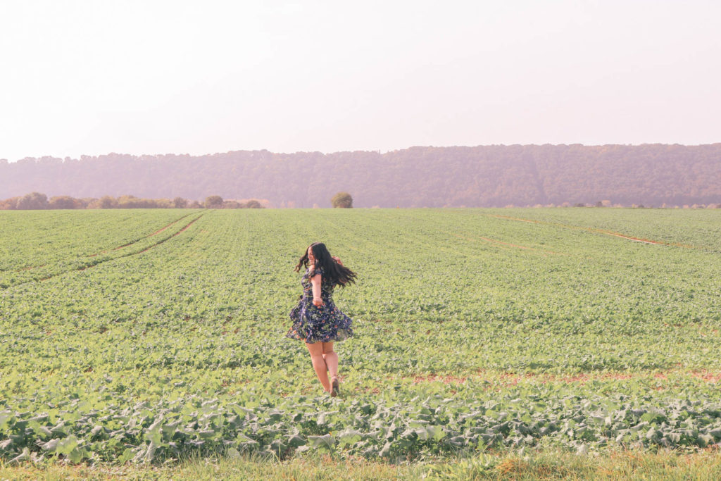 Self care checklist when you're feeling stressed and overwhelmed. Girl dancing carefree in a field in the countryside